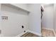 Bright laundry room with wood-look flooring, open shelving, and utility connections at 2075 Sea Hero Ct, Indianapolis, IN 46234