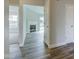 Open view from the hallway into the living room with a fireplace and neutral paint at 2075 Sea Hero Ct, Indianapolis, IN 46234