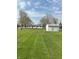 Spacious backyard with lush green grass and a shed providing ample outdoor storage at 2185 W State Road 234, Fortville, IN 46040