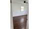 Bedroom features hardwood floors, window, and ceiling fan at 2185 W State Road 234, Fortville, IN 46040