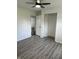 Bright bedroom with fresh white walls, gray wood-look floors, ceiling fan, and closet space at 2185 W State Road 234, Fortville, IN 46040