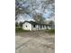 Exterior view of the house featuring an expansive driveway and manicured lawn at 2185 W State Road 234, Fortville, IN 46040