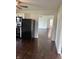 A kitchen showing dark hardwood floors, white walls, and stainless appliances at 2185 W State Road 234, Fortville, IN 46040