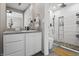 Bathroom featuring granite countertops, a sink, and a glass-enclosed shower with updated fixtures at 226 N Cleveland St # 226C, Indianapolis, IN 46204