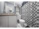 Stylish bathroom with a granite vanity and geometric shower curtain, combining elegance and functionality at 226 N Cleveland St # 226C, Indianapolis, IN 46204