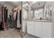 Primary bathroom with a walk-in closet and sleek granite vanity, creating a modern and functional space at 226 N Cleveland St # 226C, Indianapolis, IN 46204