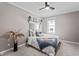 Cozy bedroom featuring a ceiling fan, natural light, and neutral tones for a relaxing atmosphere at 226 N Cleveland St # 226C, Indianapolis, IN 46204