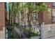Exterior view of brick apartments with iron fences, trees and walkway at 226 N Cleveland St # 226C, Indianapolis, IN 46204