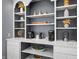 Stylish built-in shelving with decorative items, coffee station, and ample storage at 226 N Cleveland St # 226C, Indianapolis, IN 46204