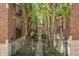 Scenic courtyard showcasing brick buildings, mature trees, and green landscaping, creating a tranquil and picturesque outdoor retreat at 226 N Cleveland St # 226C, Indianapolis, IN 46204