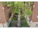 Beautiful courtyard view featuring lush trees and greenery between brick buildings, creating a serene and inviting outdoor space at 226 N Cleveland St # 226C, Indianapolis, IN 46204