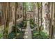Exterior view of a charming courtyard nestled between brick apartment buildings with lush landscaping at 226 N Cleveland St # 226C, Indianapolis, IN 46204