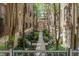 Charming courtyard with a walkway, mature trees, and manicured landscaping between brick buildings, offering a peaceful setting at 226 N Cleveland St # 226C, Indianapolis, IN 46204