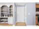 Inviting entryway with built-in shelving, modern light gray paint, and hardwood floors, creating a warm and welcoming space at 226 N Cleveland St # 226C, Indianapolis, IN 46204