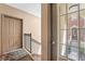 Hallway view with neutral paint, staircase, and view of building exterior at 226 N Cleveland St # 226C, Indianapolis, IN 46204