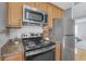 Contemporary kitchen with stainless steel appliances, granite countertops, and light wood cabinets at 226 N Cleveland St # 226C, Indianapolis, IN 46204