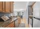 Well-lit kitchen features stainless steel appliances, granite countertops, and hardwood floors with views to the dining area at 226 N Cleveland St # 226C, Indianapolis, IN 46204