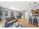 Spacious living room with hardwood floors, open to the kitchen and dining area at 226 N Cleveland St # 226C, Indianapolis, IN 46204