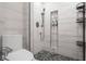 Bathroom shower featuring updated fixtures, rock floor, and built-in shelves at 226 N Cleveland St # 226C, Indianapolis, IN 46204