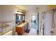 Bathroom featuring wood-framed mirrors and a vanity with dual sinks and tile floor at 2441 Longleaf Dr, Greenwood, IN 46143