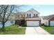 Charming home with a brick facade, two car garage, and lake in backyard at 2441 Longleaf Dr, Greenwood, IN 46143