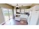 Bright kitchen with white cabinetry, stainless appliances, wood floors, and backyard access at 2441 Longleaf Dr, Greenwood, IN 46143