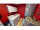 Bright laundry room with white washer, dryer, cabinets and red walls at 2441 Longleaf Dr, Greenwood, IN 46143