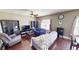 This large living area has dark hardwood floors, a ceiling fan, and plentiful natural light at 2441 Longleaf Dr, Greenwood, IN 46143