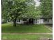 Traditional single-story home with a shaded front yard and a cozy front porch at 2508 N Routiers Ave, Indianapolis, IN 46219
