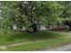 Traditional single-story home with a shaded front yard and a cozy front porch at 2508 N Routiers Ave, Indianapolis, IN 46219