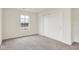 Bright bedroom with neutral carpet, closet, and a large window for ample natural light at 2712 Glade Ave, Plainfield, IN 46168