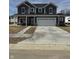 Charming two-story home with gray siding, white trim, large garage, and concrete driveway at 2712 Glade Ave, Plainfield, IN 46168