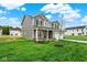 Charming home showcasing a well-kept lawn, gray siding, and a welcoming front porch at 2712 Glade Ave, Plainfield, IN 46168
