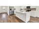 Modern kitchen featuring white cabinets, stainless steel appliances, and a center island with countertop seating at 2712 Glade Ave, Plainfield, IN 46168