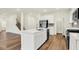 Open-concept kitchen with a large island, stainless steel appliances, and hardwood floors perfect for entertaining at 2712 Glade Ave, Plainfield, IN 46168