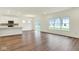 Bright living room with vinyl flooring, a sliding door to outside, recessed lighting, and modern kitchen at 2712 Glade Ave, Plainfield, IN 46168