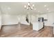 Spacious living room with vinyl plank flooring, recessed lighting, and an island kitchen with stainless appliances at 2712 Glade Ave, Plainfield, IN 46168