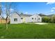 The backyard has a large grassy area, a concrete pad, and a yellow back door at 2833 Hervey St, Indianapolis, IN 46203