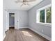This bright bedroom has newer windows, neutral paint, and luxury vinyl plank flooring at 2833 Hervey St, Indianapolis, IN 46203