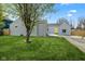 Charming home featuring a vibrant yellow front door, light gray siding, and a well-manicured lawn at 2833 Hervey St, Indianapolis, IN 46203
