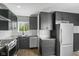 Modern kitchen with stainless steel appliances, sleek black cabinetry, and butcher block countertops at 2833 Hervey St, Indianapolis, IN 46203