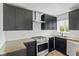 Modern kitchen with stainless steel appliances, sleek black cabinetry, and butcher block countertops at 2833 Hervey St, Indianapolis, IN 46203