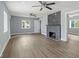 Spacious living room with a modern fireplace, ample natural light, and stylish ceiling fans at 2833 Hervey St, Indianapolis, IN 46203