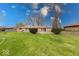 Spacious backyard featuring a well-maintained lawn and mature landscaping creating a serene outdoor retreat at 3303 Busy Bee Ln, Indianapolis, IN 46227