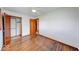 Bright bedroom with hardwood floors, ceiling fan, and closet space at 3303 Busy Bee Ln, Indianapolis, IN 46227