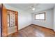 Bedroom featuring hardwood floors, a ceiling fan, and an open doorway at 3303 Busy Bee Ln, Indianapolis, IN 46227