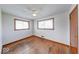 This bedroom is brightly lit by two windows and has beautiful hardwood floors at 3303 Busy Bee Ln, Indianapolis, IN 46227