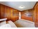 Wood-paneled living room with built-in shelves and cabinets, perfect for storage and organization at 3303 Busy Bee Ln, Indianapolis, IN 46227
