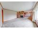 Spacious living room boasts a brick fireplace, carpet flooring, and neutral paint colors at 3303 Busy Bee Ln, Indianapolis, IN 46227