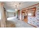 Open concept living room with an ornate fireplace, decorative wall paper, and access to the kitchen at 3303 Busy Bee Ln, Indianapolis, IN 46227